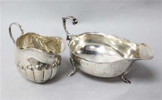 A silver sauceboat and a cream jug.